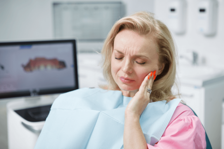 mature woman having toothache sitting dental chair